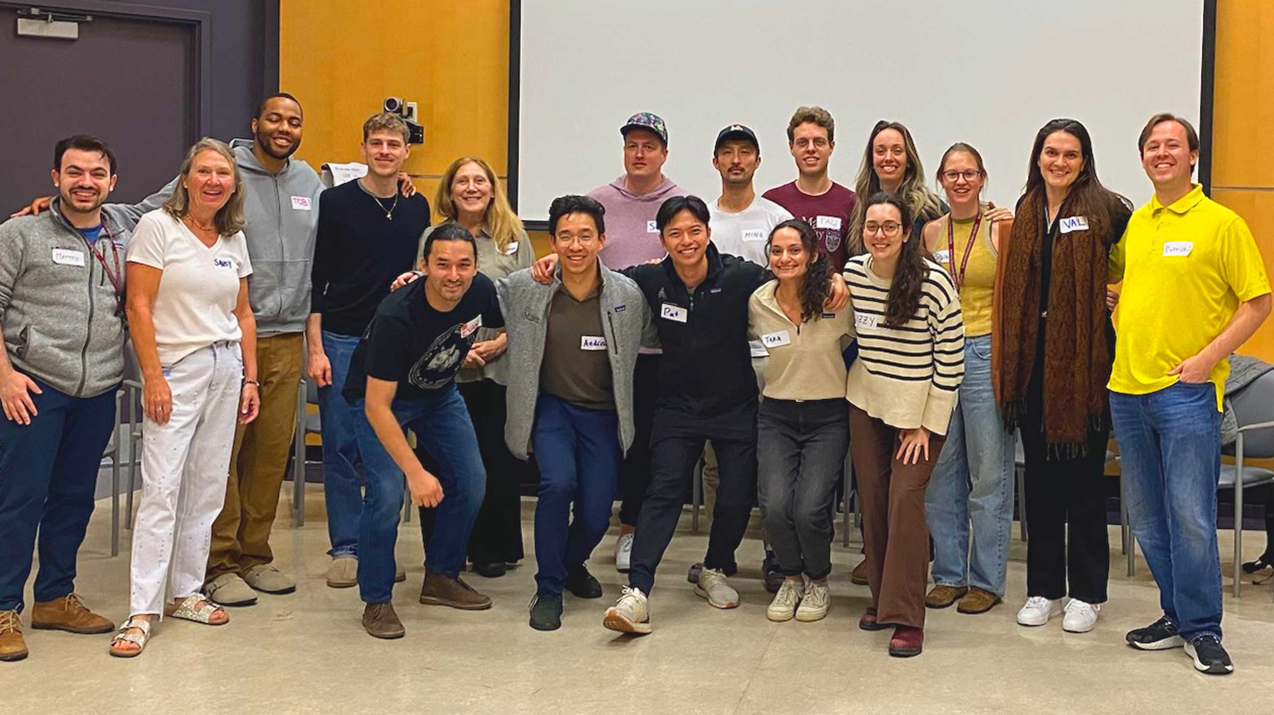 A large Railway City Improv class smiling together after an in-person session